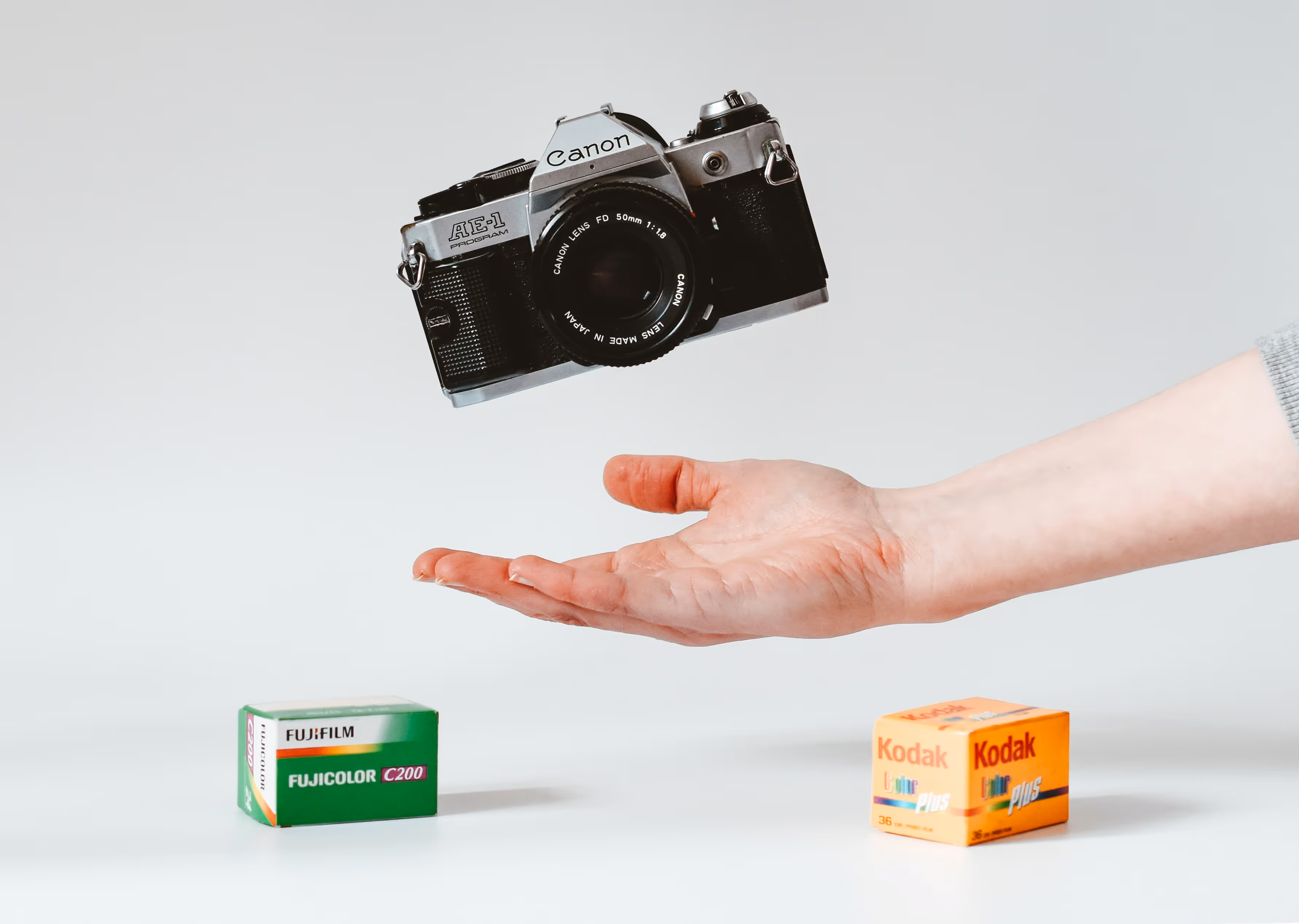 A vintage film camera held in hand, capturing the analog photography revival sweeping Hong Kong's younger generation.
